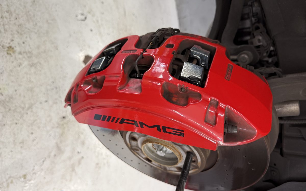 Brake caliper and rotor exposed during brake service at America Auto Repair in Doral, FL