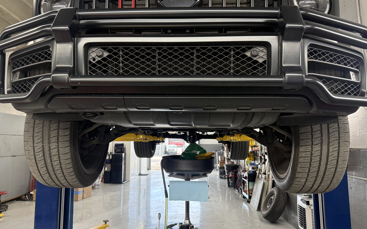 Vehicle raised on a lift during an oil change at America Auto Repair in Doral, FL