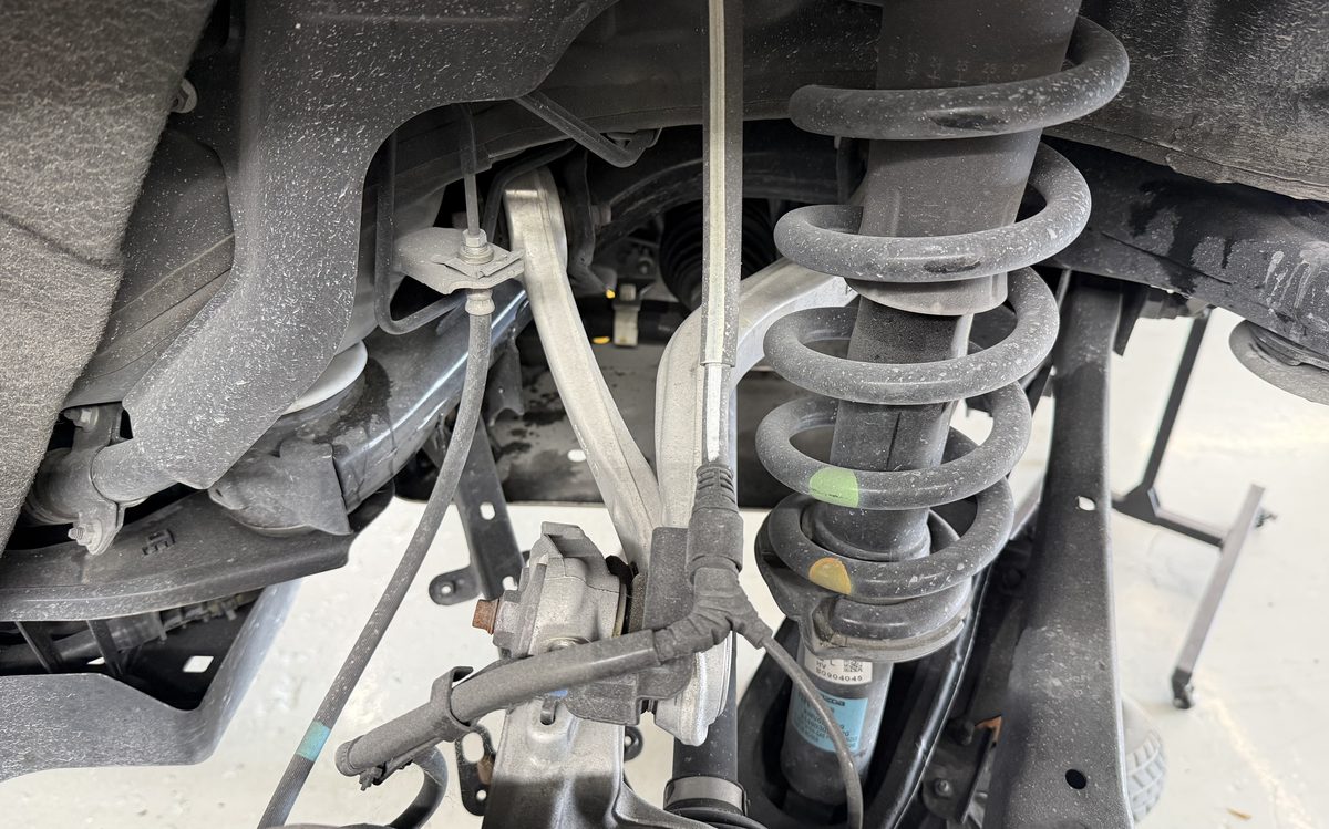 Front suspension strut, coil spring and control arm inspected at America Auto Repair in Doral, FL